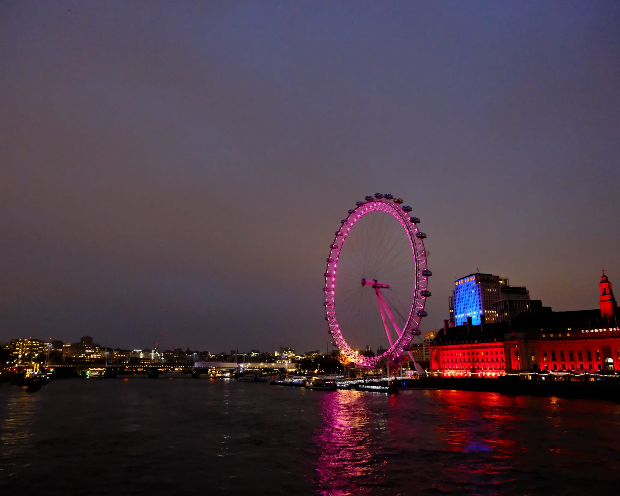 a picture of the London eye lit up in bright colours