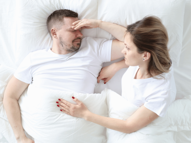 a man a woman lying on a bed