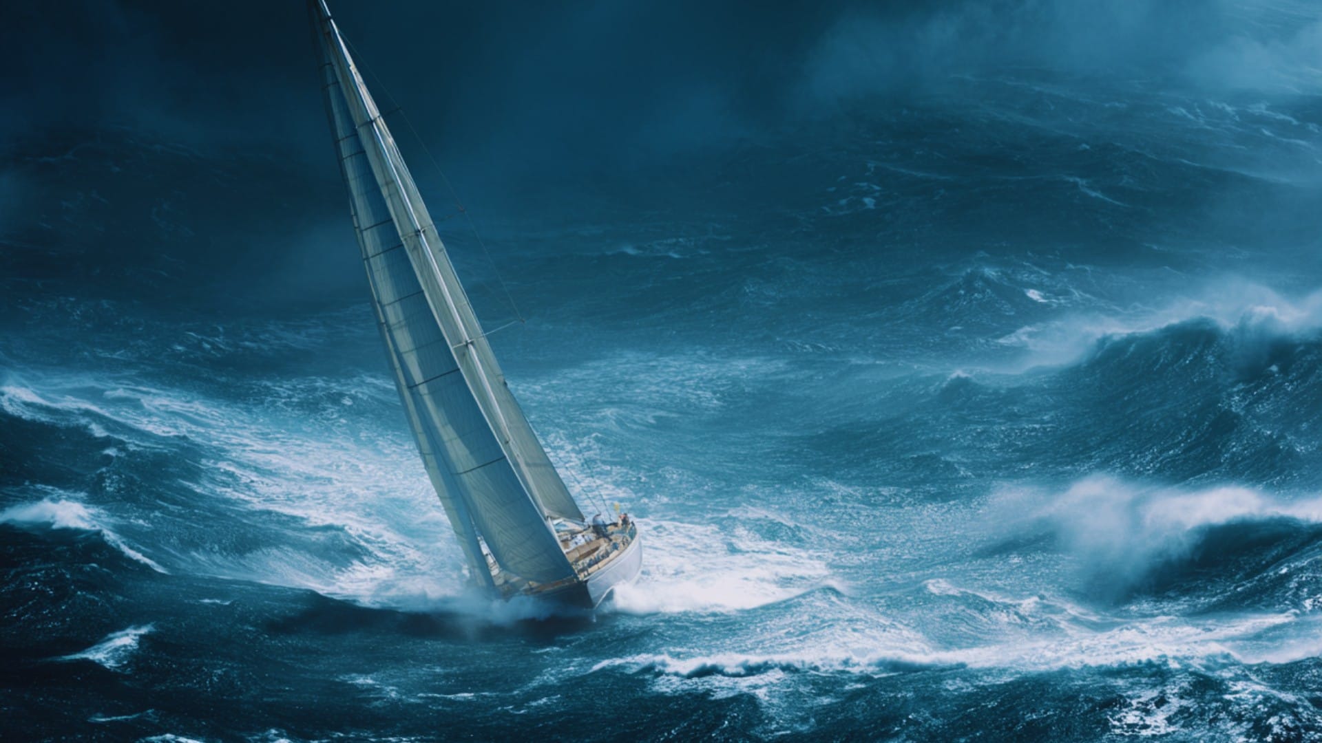 a monohul yacht racing through the high seas