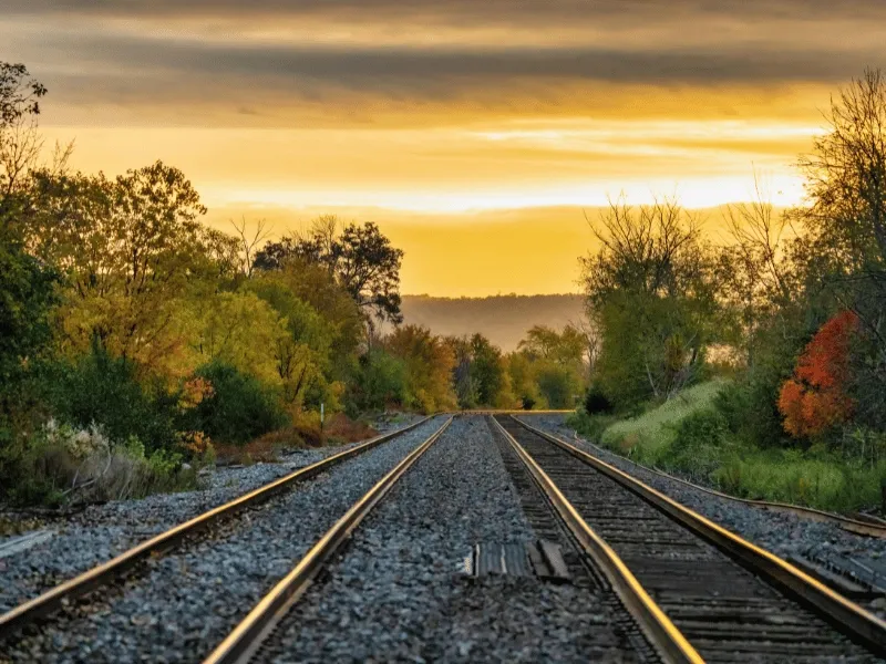 A picture of train tracks and a bright sky