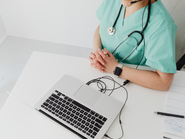 a piture of a doctor sat at her desk