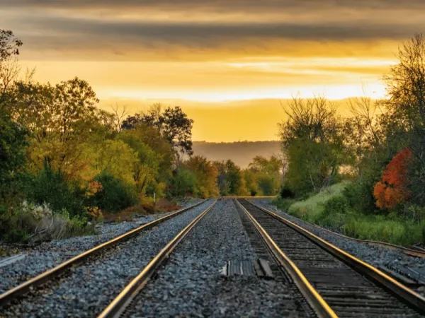 A picture of train tracks and a bright sky