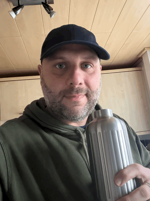 a picture of a man holding a water bottle